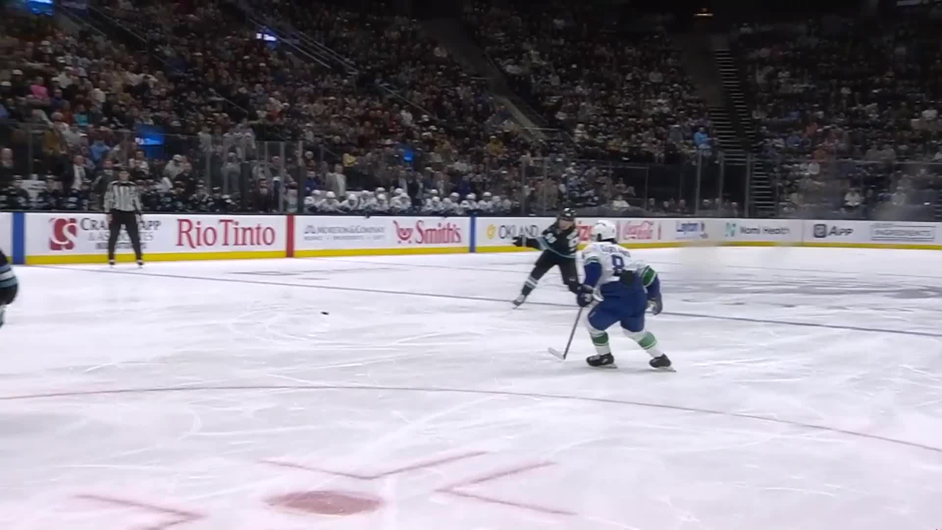 NHL players shaking hands after a trade announcement on the ice, with team logos and deadline clock in the background